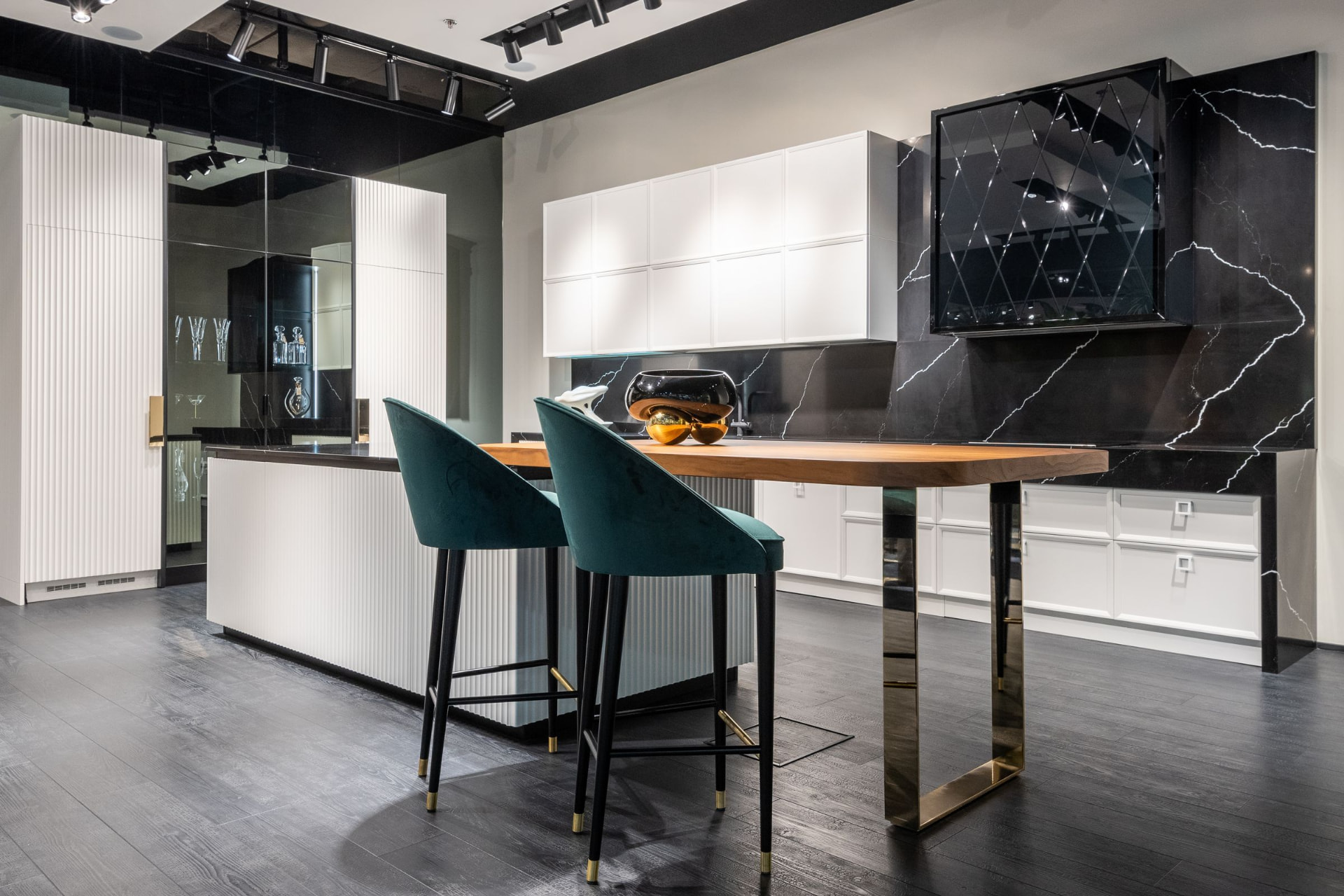 White cabinetry with a fluted island, dark marble backsplash and bar seating
